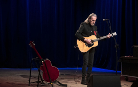 John Porter gra na gitarze i śpiewa na scenie CKK