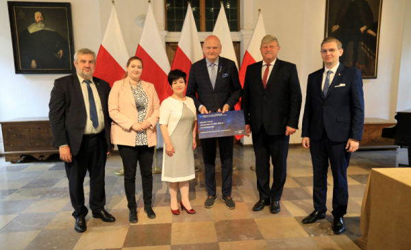 Na zdjęciu: prezydent Michał Zaleski trzyma symboliczną promesę  na dofinansowani budowy szkoły przy ul. Strzałowej