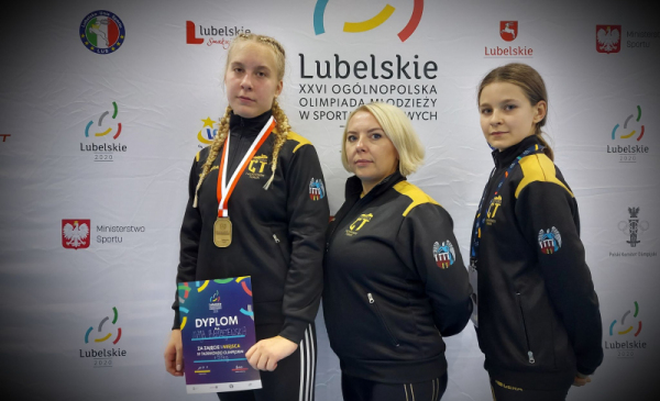 Mistrzyni taekwondo Maja Błażejewicz z medalem i dyplomem, z trenerką oraz drugą zawodniczką
