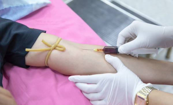 Na zdjęciu lekarz pobiera krew od dawcy