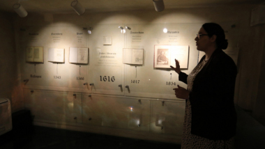 Na zdjęciu: przewodniczka muzealna opowiada o wystawie w Domu Kopernika